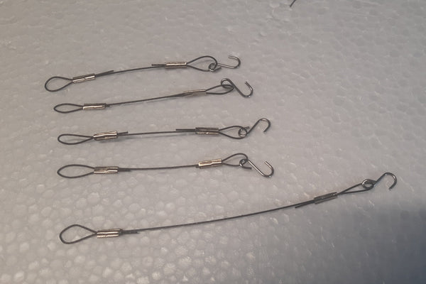 Five metal wire fishing hooks with swivels used to connect from suspension ring to 4 resonating tubes along with from bottom or striker ring to top of wind sail.